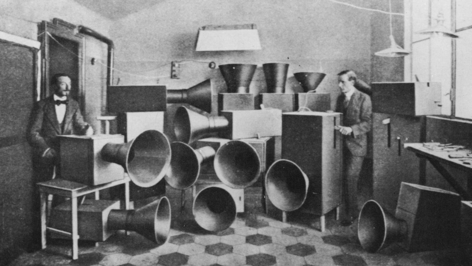 Historic photograph of Luigi Russolo’s Intonarumori noise instruments, showing large mechanical sound boxes and horn-shaped speakers used in early futurist sound experiments.