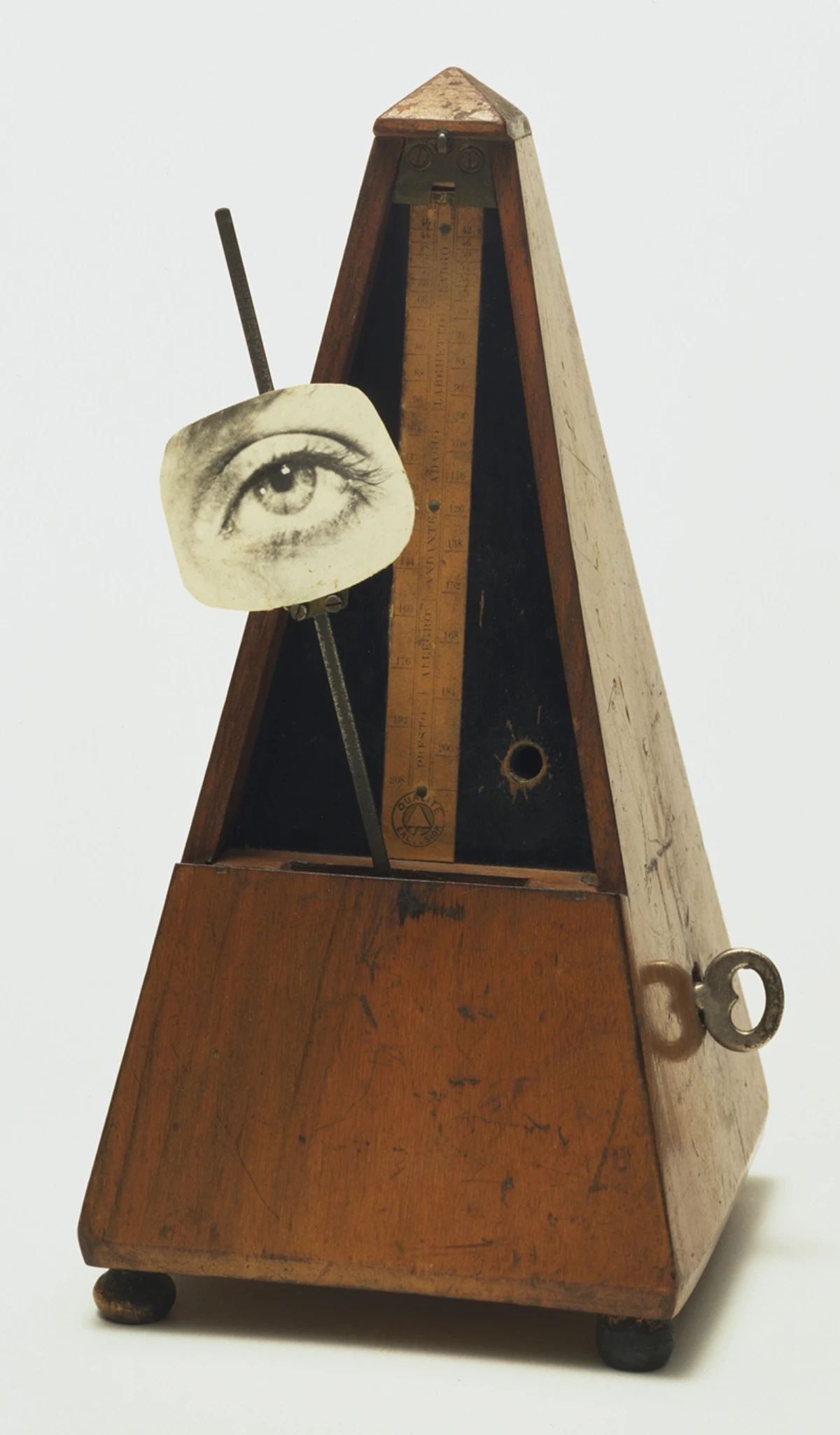 Man Ray’s Indestructible Object, a wooden metronome with a photographic eye attached to its swinging arm, representing an early surrealist sound sculpture.