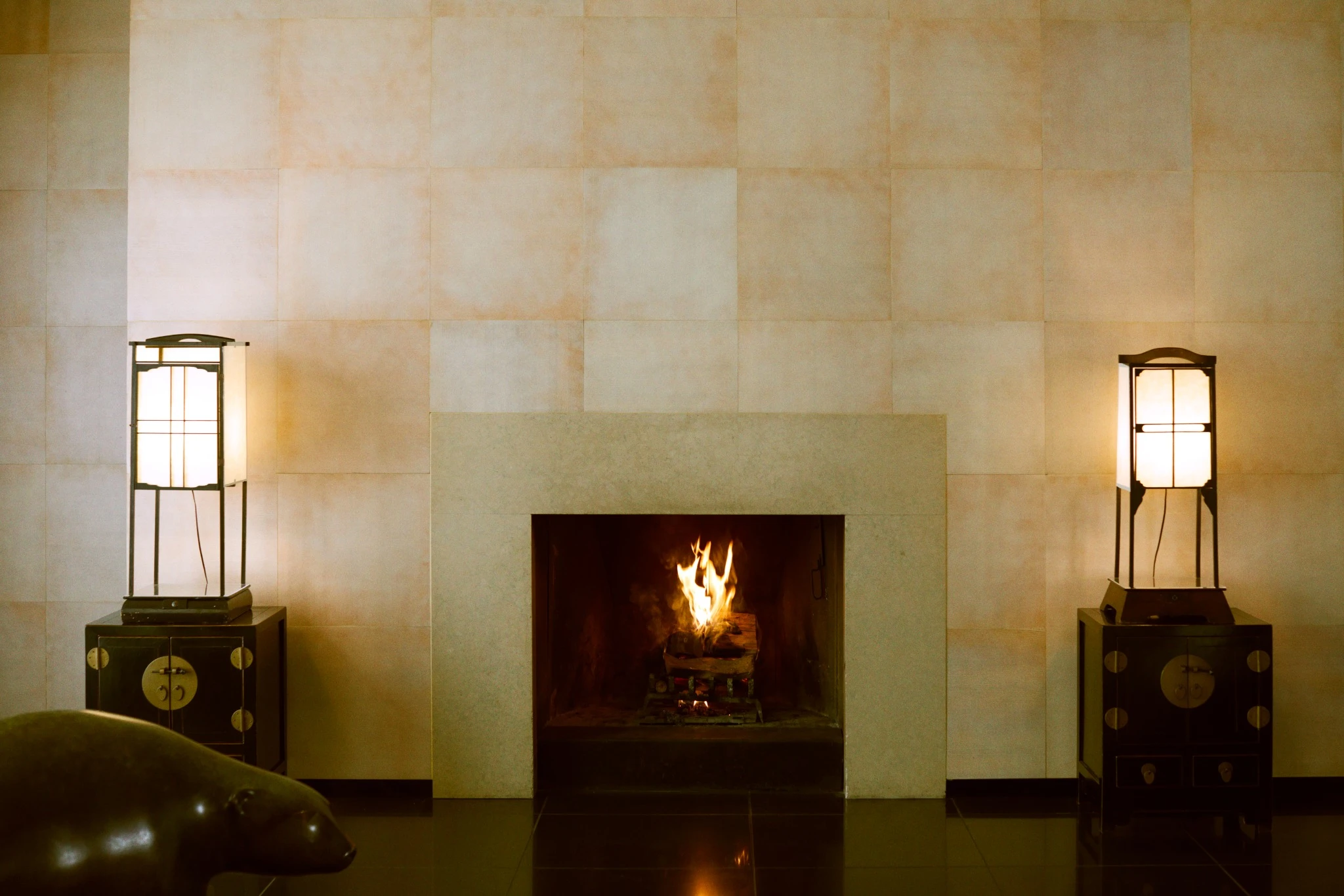 Interior of Giorgio Armani’s home at Via Borgonuovo 21 in Milan, featuring a minimalist fireplace and sculptural furnishings. Photograph by Luca De Santis.
