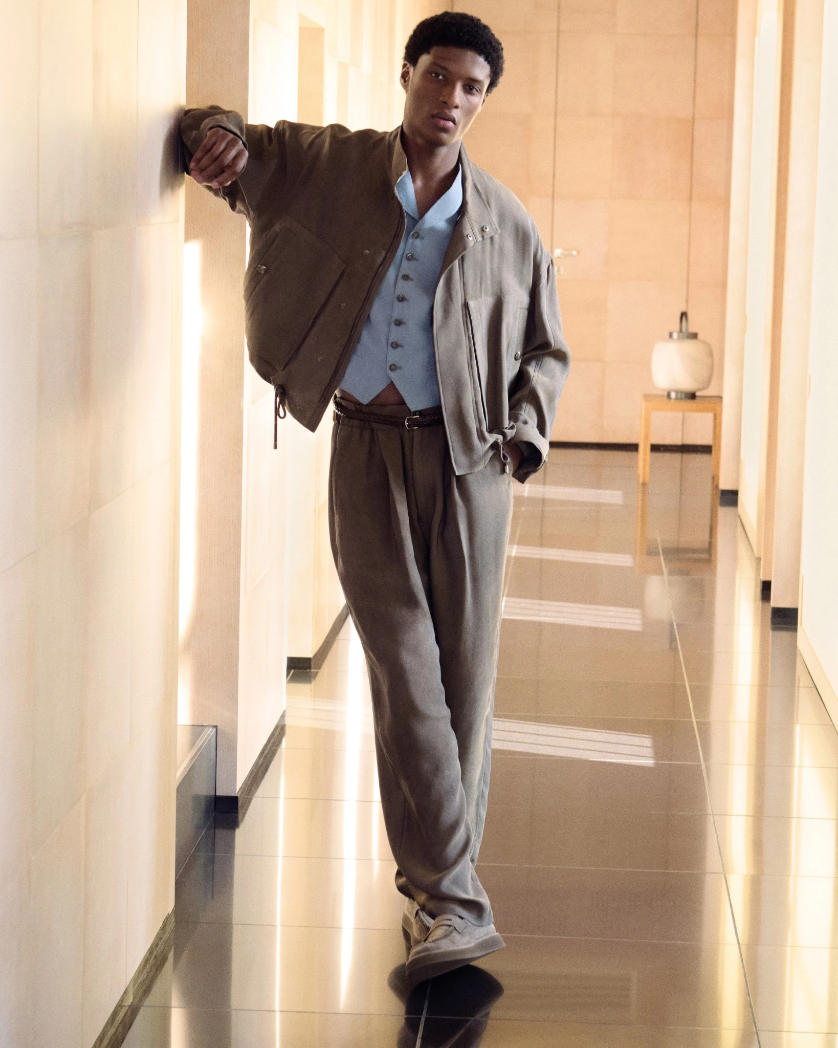 Aboubakar Conte photographed for the Giorgio Armani Spring Summer 2026 campaign, wearing relaxed tailoring in soft neutral tones inside the designer’s Milan residence
