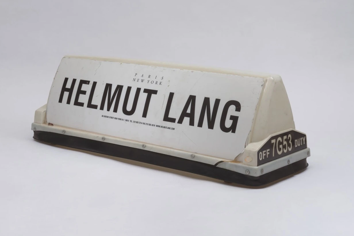 Helmut Lang New York City Taxi Top from 2002 featuring the Helmut Lang logo in black lettering on a white illuminated taxi roof sign