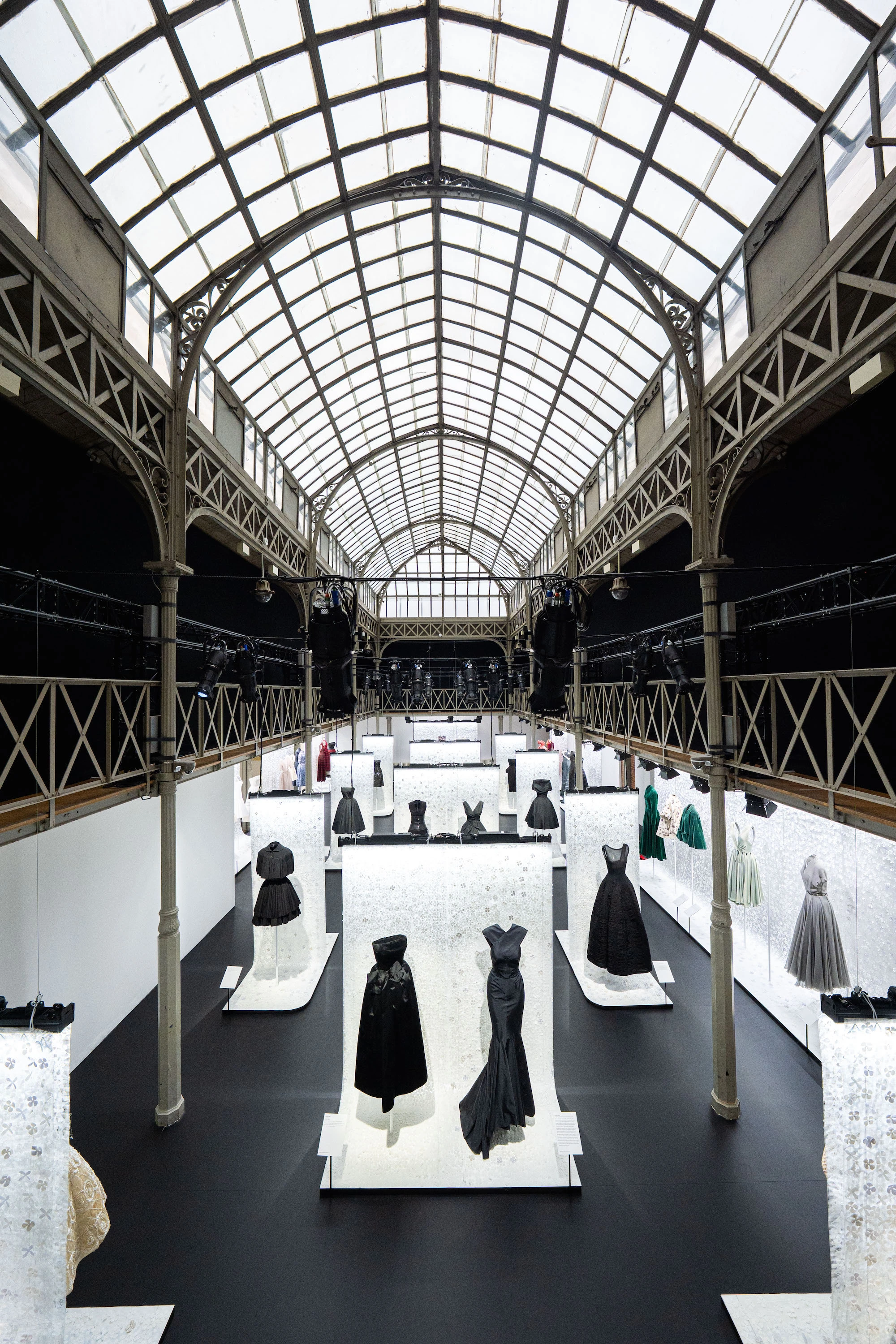 Azzedine Alaia and Christian Dior haute couture gowns displayed on mannequins in museum installation