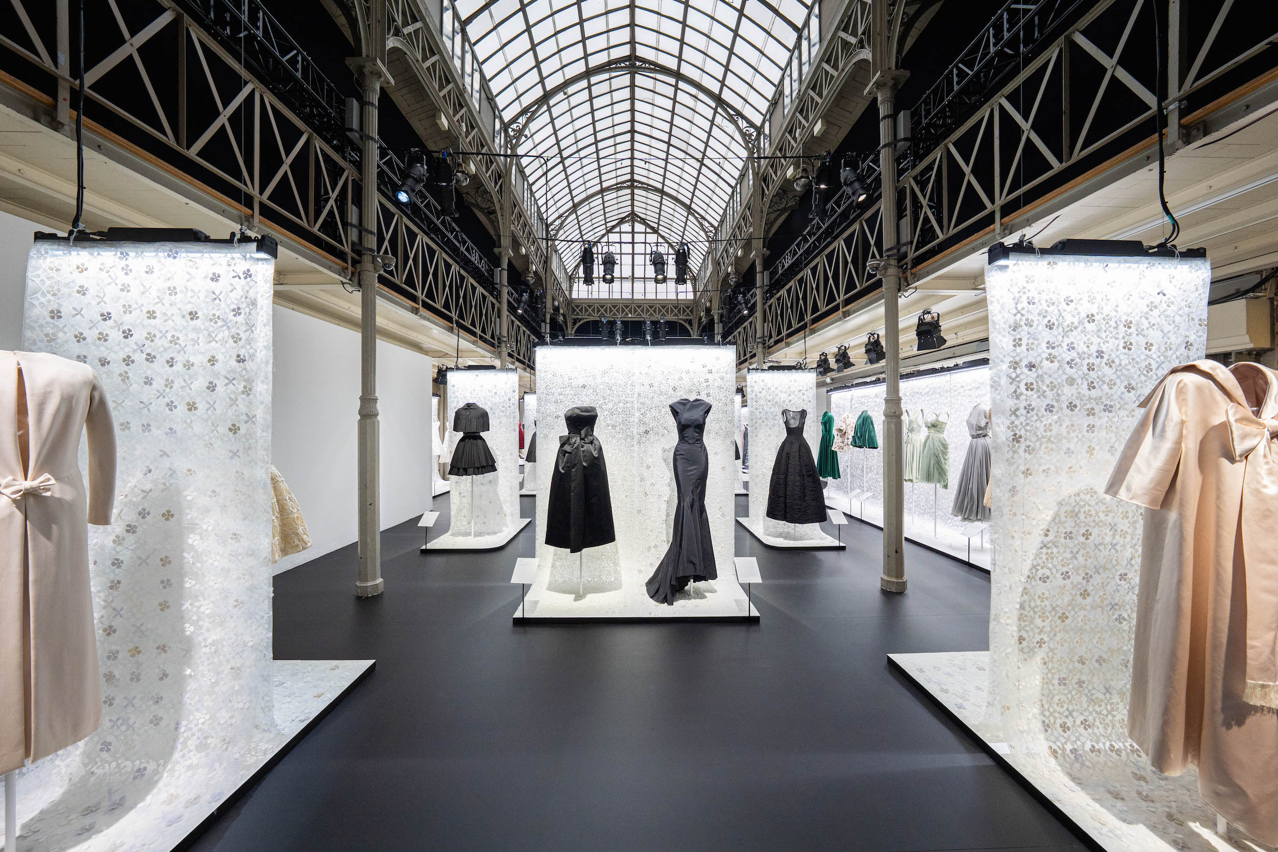 Azzedine Alaia and Christian Dior haute couture exhibition installation with black and pastel gowns on mannequins