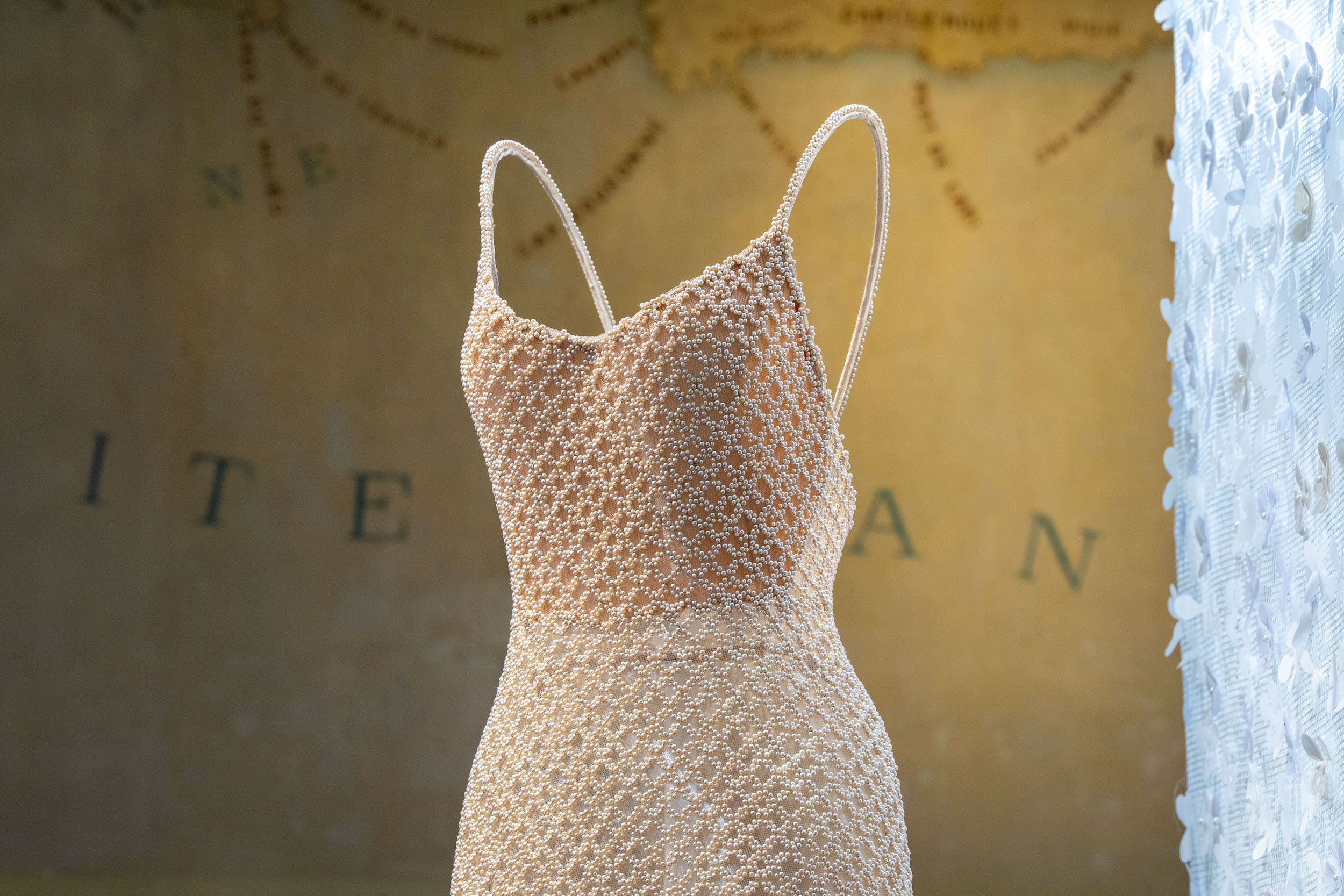 Pearl-embroidered slip dress on mannequin, Azzedine Alaia and Christian Dior exhibition installation