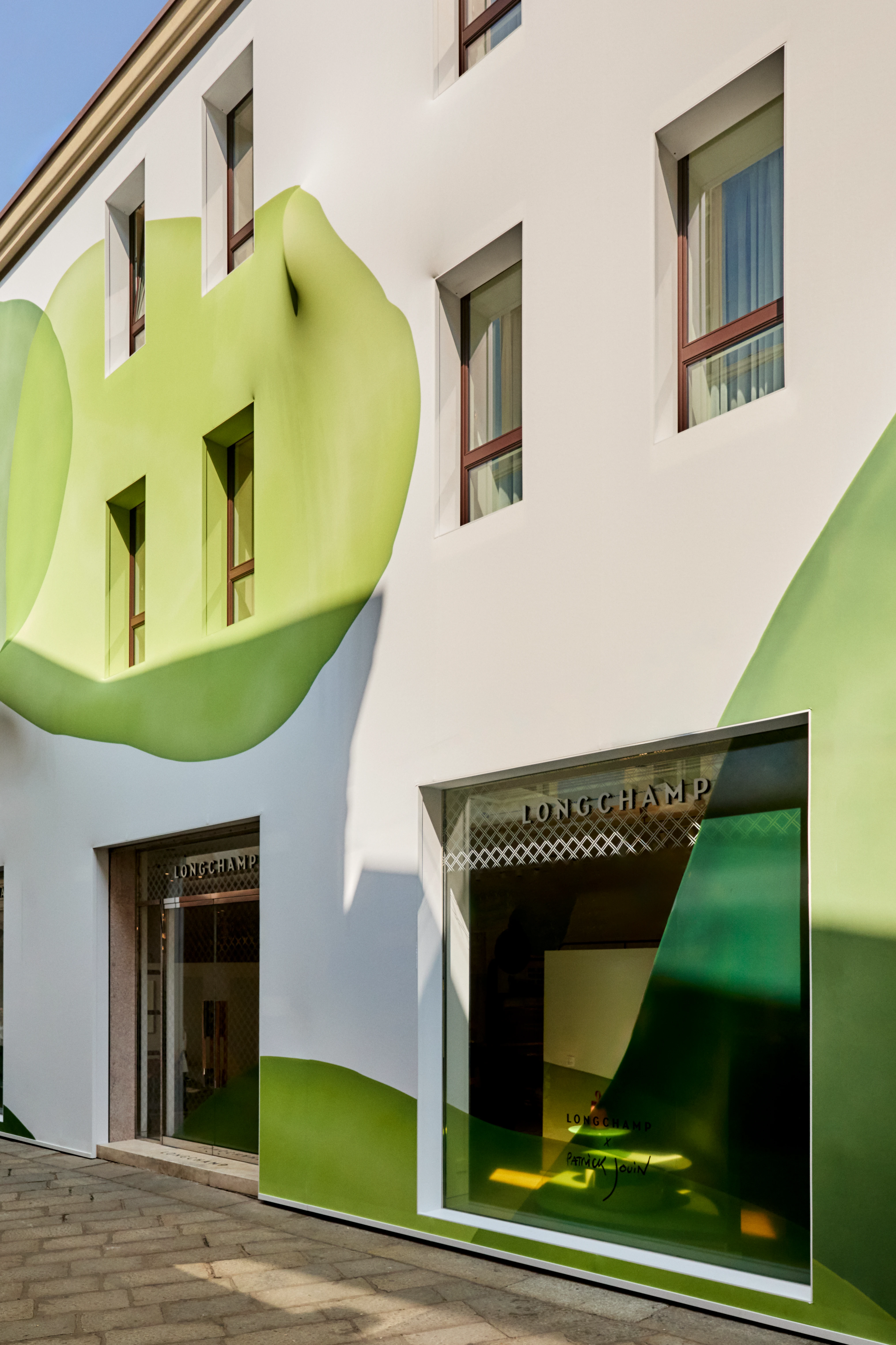 Longchamp x Patrick Jouin store installation with green botanical mural, Via della Spiga, Milan