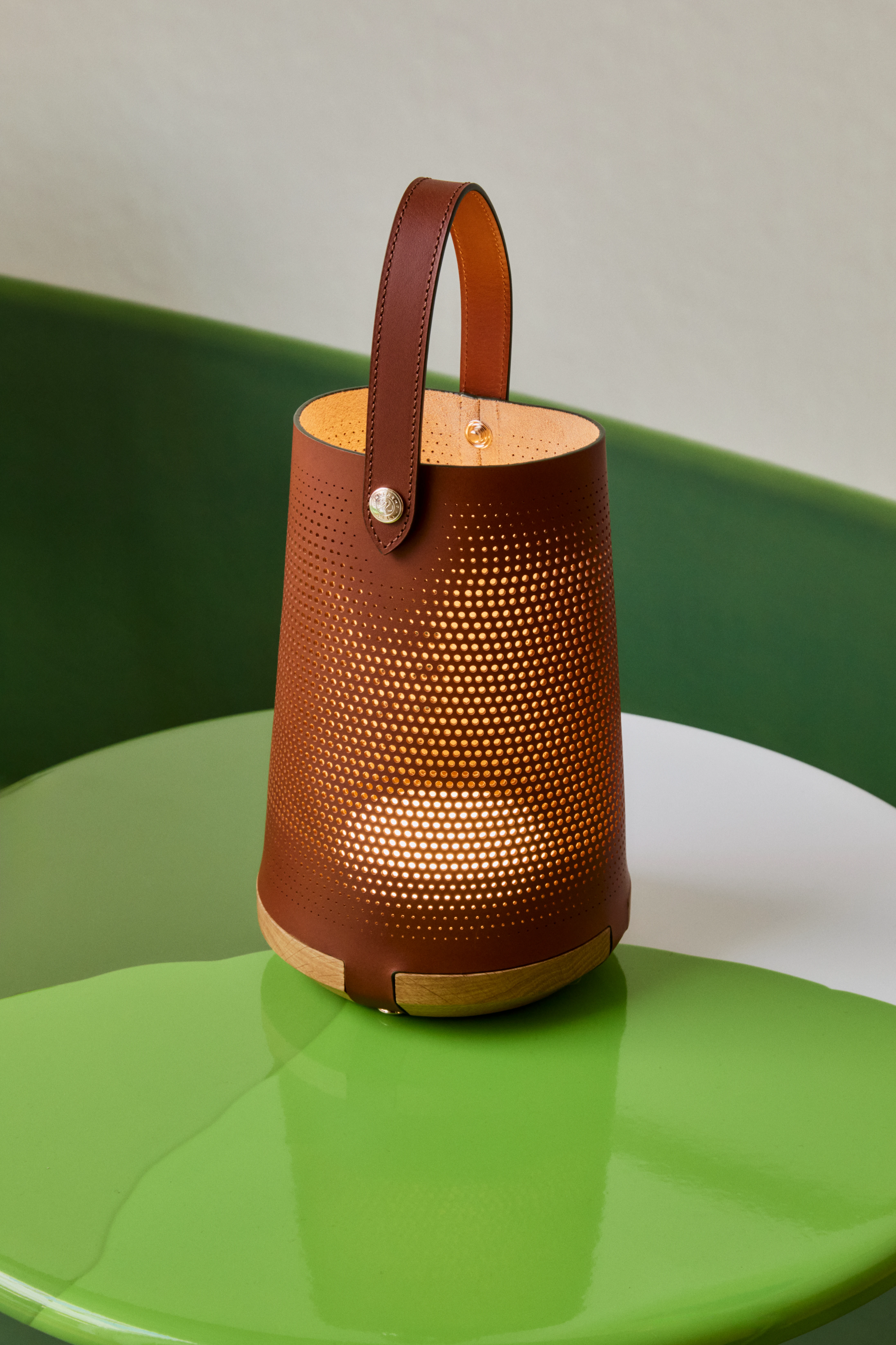 Longchamp x Patrick Jouin perforated leather portable lantern on green table, Milan 2026