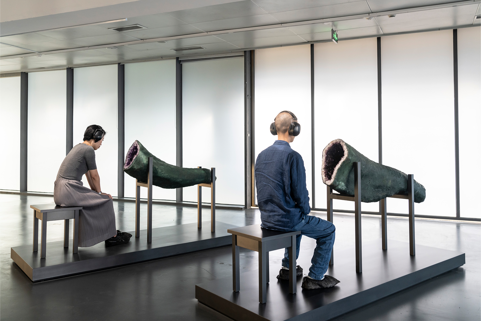 Visitors with headphones contemplate amethyst geode sculptures in Marina Abramovi's Transforming Energy at MAM Shanghai