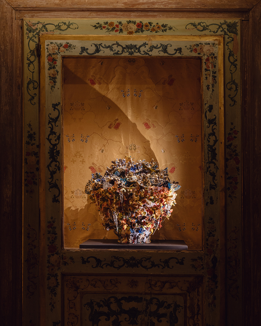 Ornate ceramic vase displayed in gilded niche at Dries Van Noten Foundation exhibition, photo by Matteo De Mayda