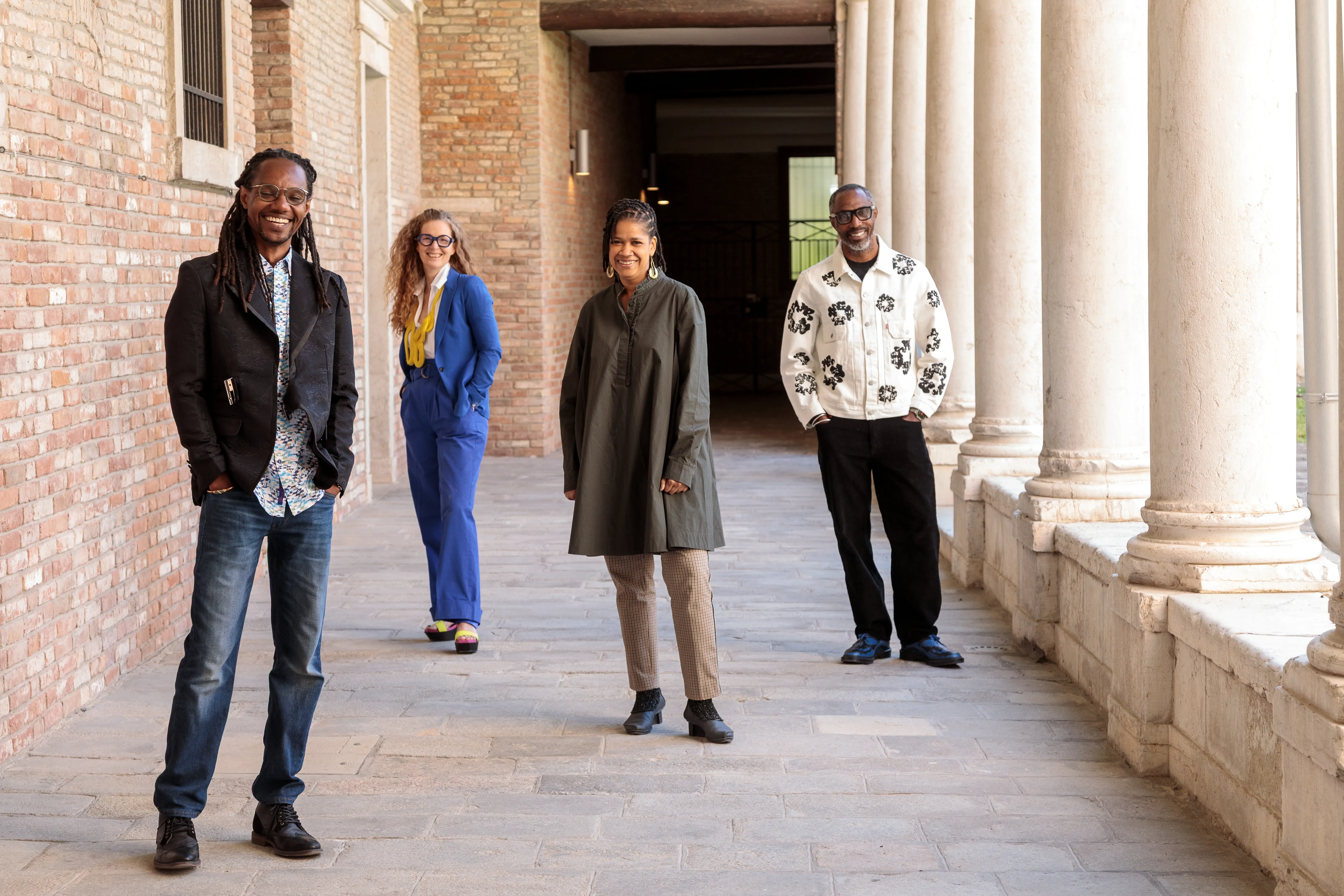 Lavar Munroe, Amanda Coulson, Dr. Krista Thompson, and John Cox stand in a colonnaded walkway