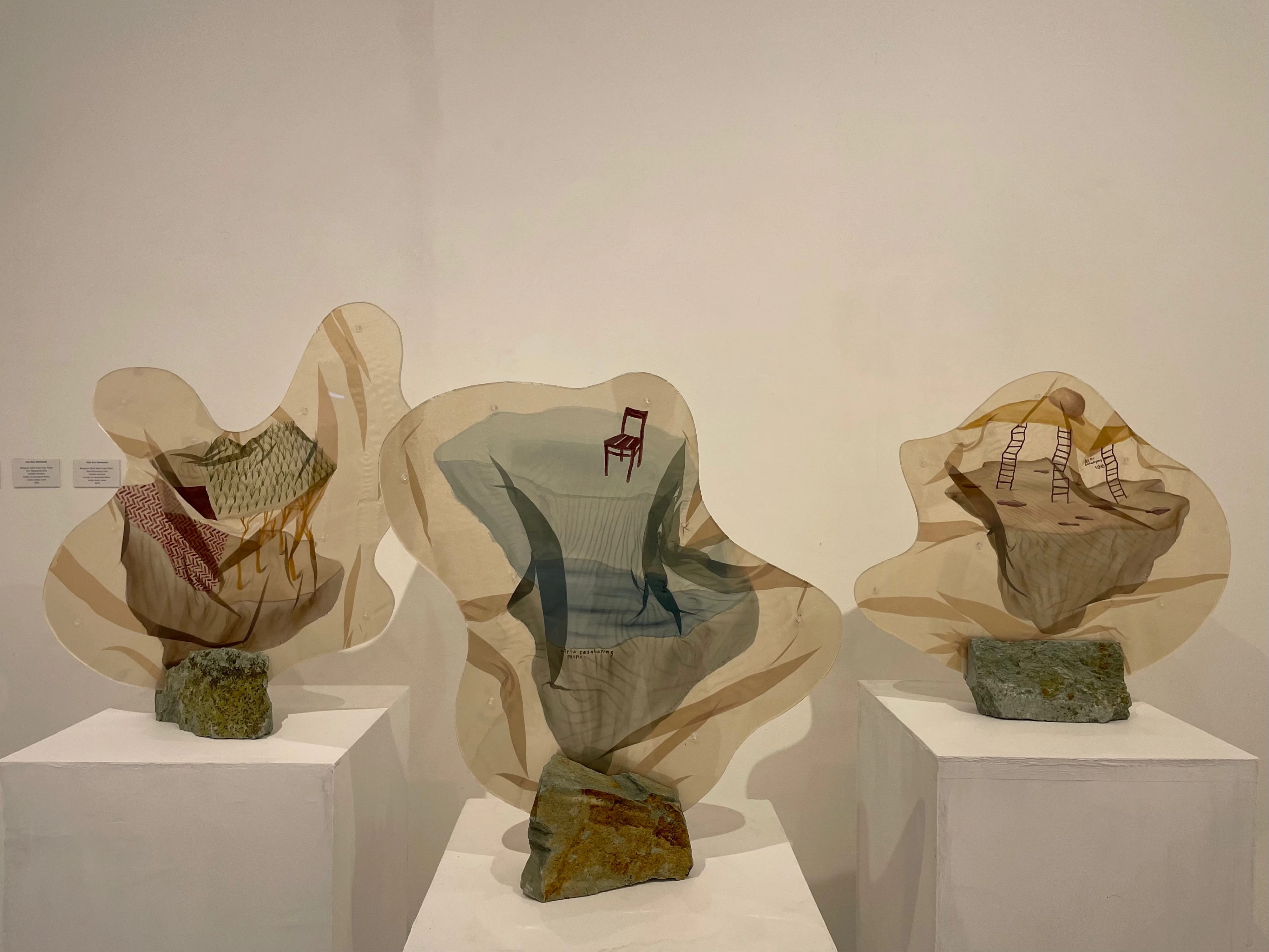 Dian Suci 'Searching Land in the Land Word' 2022 acrylic on transparent fabric with stones, gallery installation
